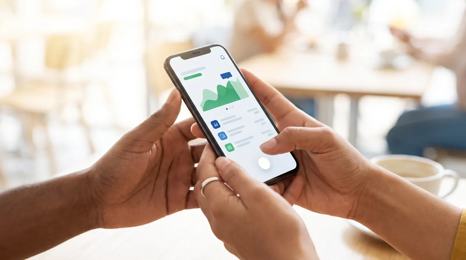 Hands holding a smartphone with a banking app open
